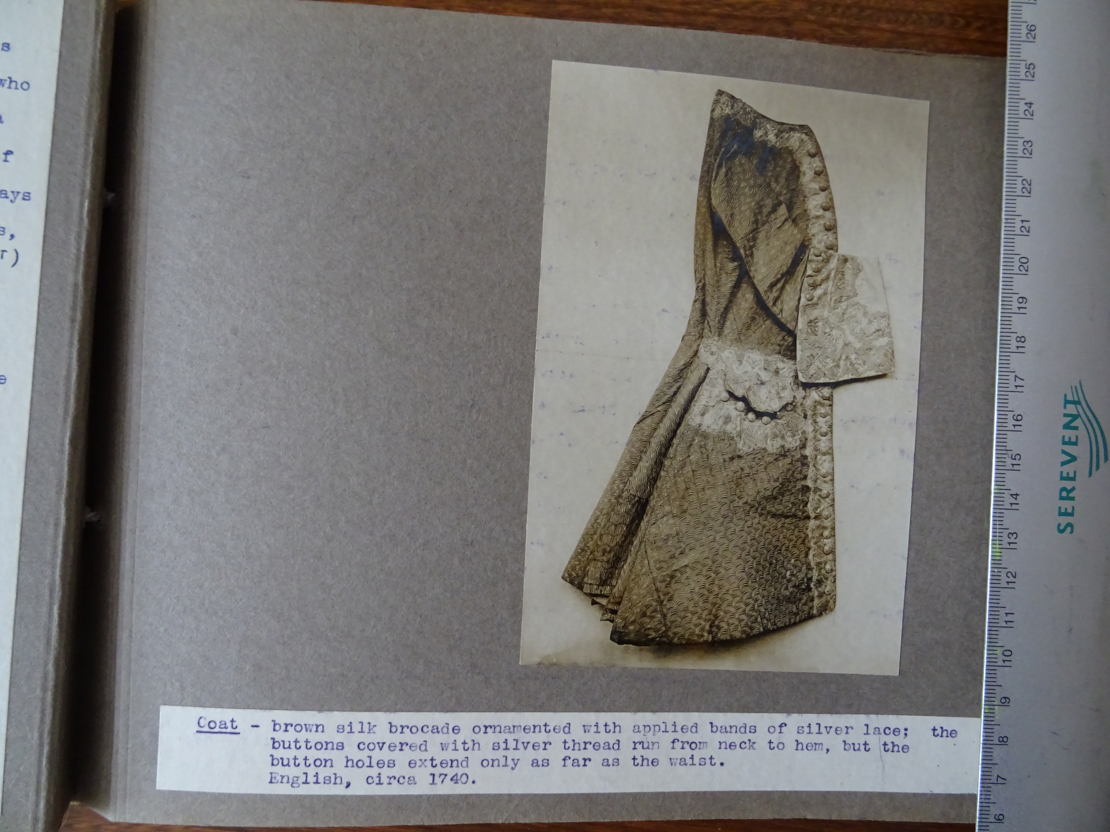 Photo of a brown silk coat, brocade ornamented with applied bands of silver lace